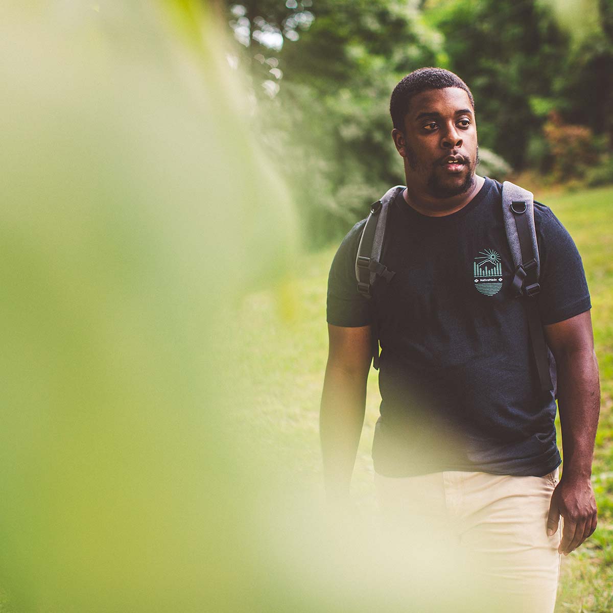 Model wearing NativeMade Mountain Tee in the woods