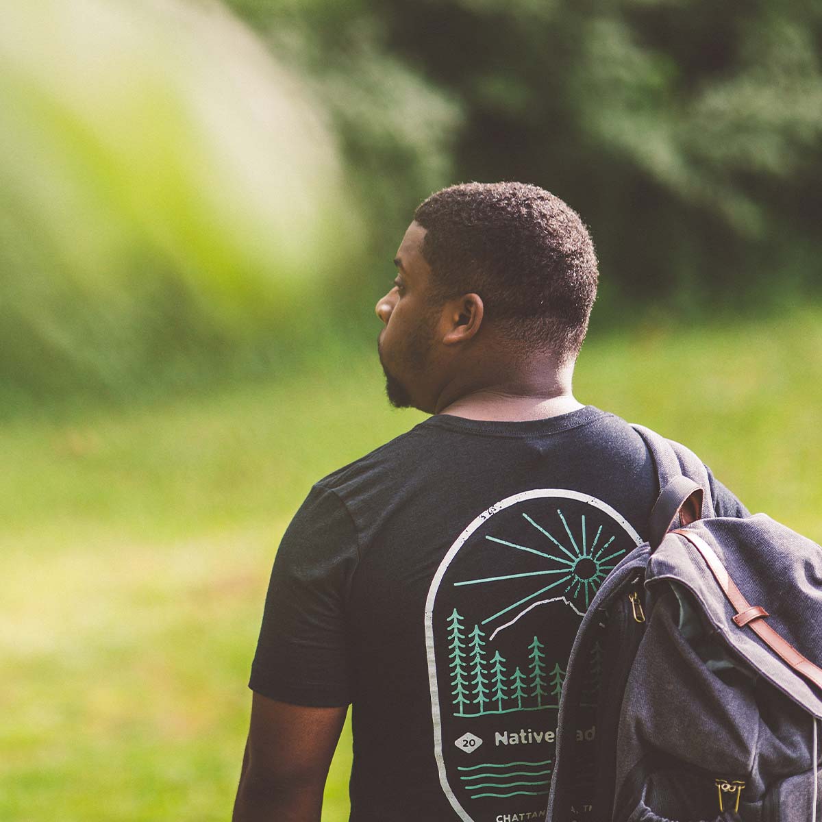 Model wearing NativeMade Mountain Tee in the woods