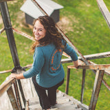 Model wearing Prentice Cooper State Forest long sleeve while climbing a watch tower